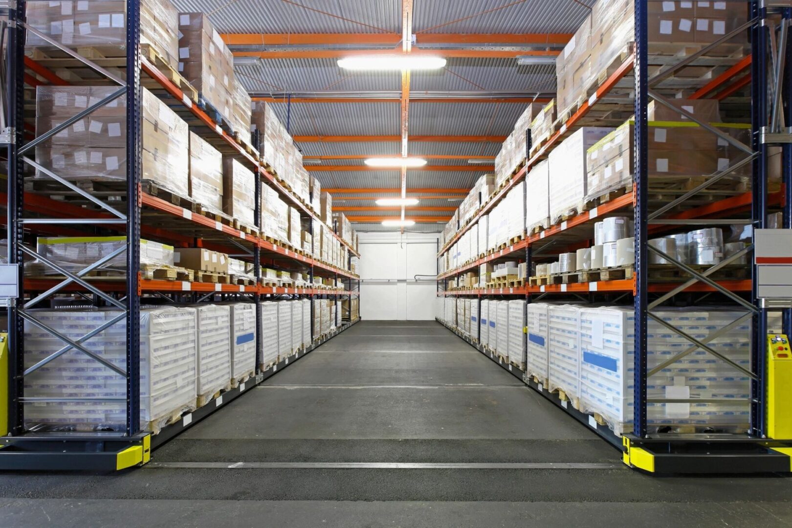 A warehouse with many shelves of boxes and packages.