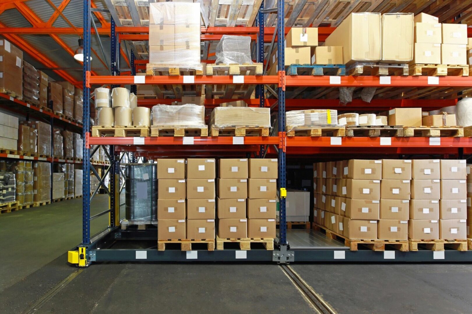 A warehouse with boxes and other items on the shelves.
