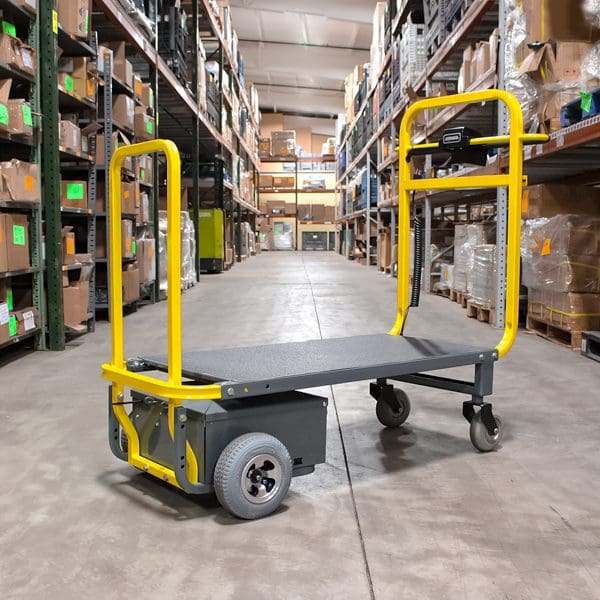 Warehouse cart in aisle with shelves.
